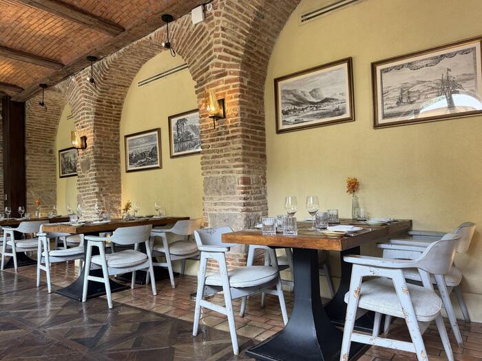 Brick-vaulted terrace dining room set for lunch service