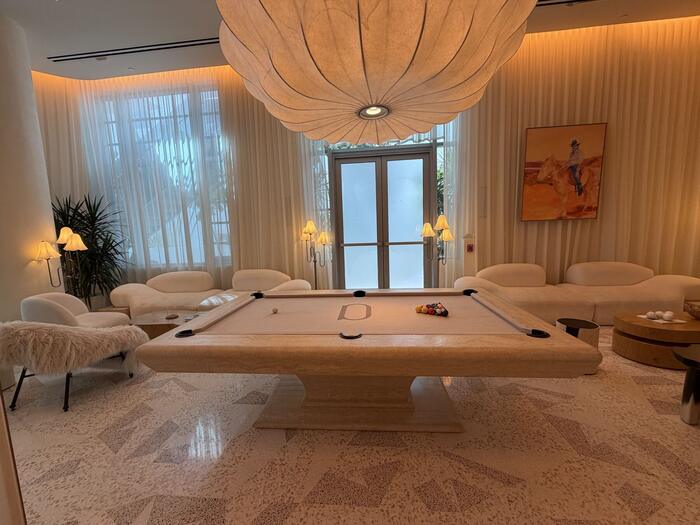 Lounge with marble pool table and terrazzo flooring
