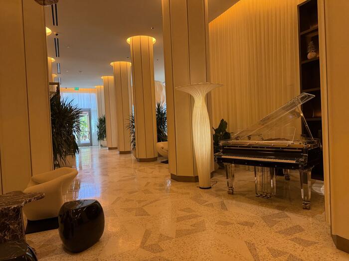 Hotel lobby corridor with grand piano and terrazzo floor