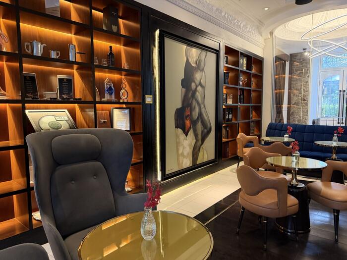 Guest lounge with display shelving and blue sofa seating